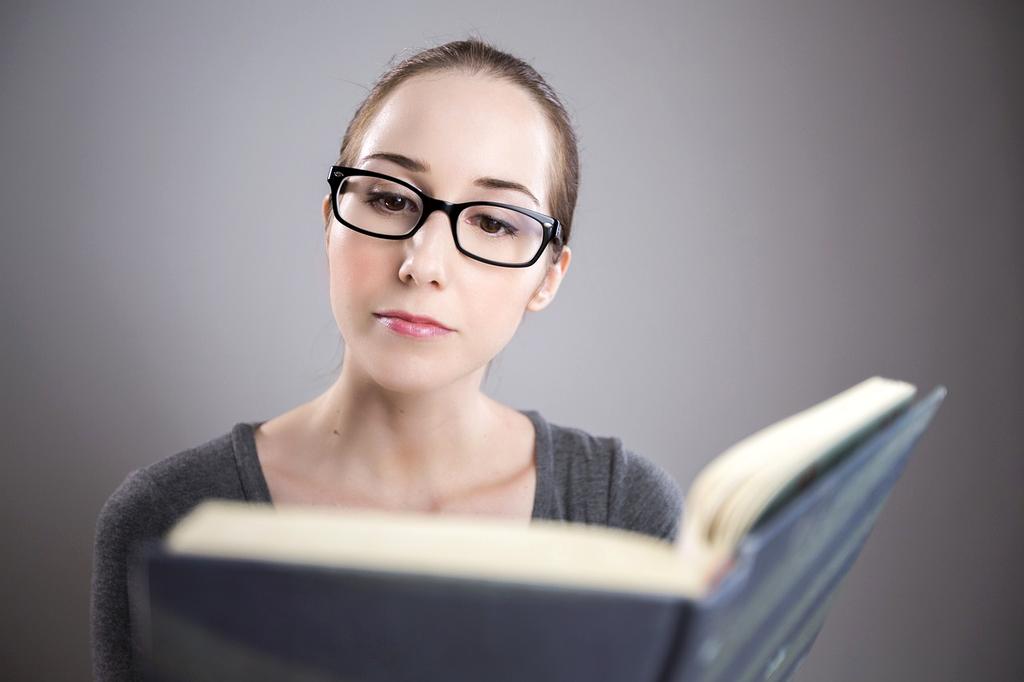 Young woman reading on a tablet at a café