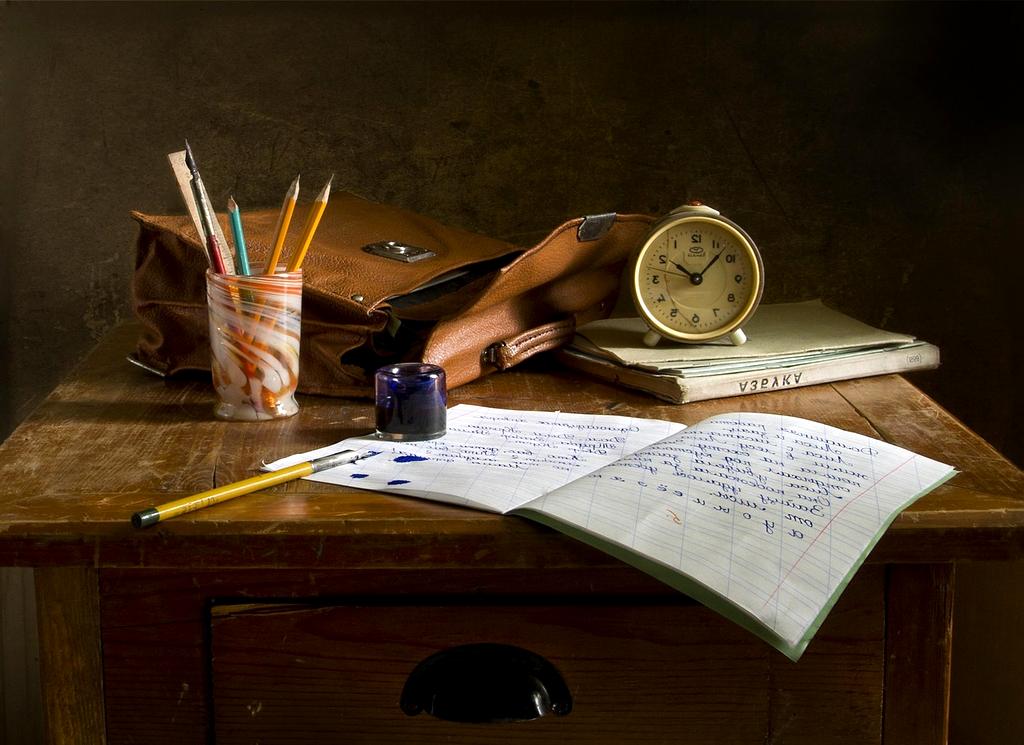 Writing desk with notebook, keyboard, and coffee cup